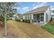 Backyard featuring a screened porch, well-maintained lawn, and lush landscaping at 2832 Thompson Bluff Dr, Cary, NC 27519