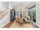 Bright dining area with banquette seating, elegant chandelier, and sliding glass doors to outdoor patio at 2832 Thompson Bluff Dr, Cary, NC 27519