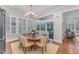 Cozy dining area featuring a unique chandelier, banquette seating, and sliding doors offering backyard views at 2832 Thompson Bluff Dr, Cary, NC 27519