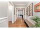 Inviting hallway with hardwood floors, elegant wainscoting, and decorative artwork on the walls at 2832 Thompson Bluff Dr, Cary, NC 27519
