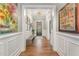 Welcoming hallway featuring hardwood floors, decorative wall trim, and an inviting view to the front door at 2832 Thompson Bluff Dr, Cary, NC 27519