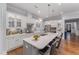 Modern kitchen with a large island, white cabinets, stainless steel appliances, and stylish pendant lighting at 2832 Thompson Bluff Dr, Cary, NC 27519