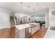 Bright, open kitchen featuring a large island with seating and open views into the dining area and living room at 2832 Thompson Bluff Dr, Cary, NC 27519