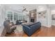Comfortable living room with stone fireplace, built-in shelves, and large windows providing natural light at 2832 Thompson Bluff Dr, Cary, NC 27519