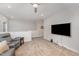 Bright living room with a large TV, cozy seating, and a neutral color palette at 2832 Thompson Bluff Dr, Cary, NC 27519