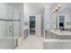Spacious main bathroom with a glass shower, soaking tub, double vanity, and an open doorway to the bedroom at 2832 Thompson Bluff Dr, Cary, NC 27519