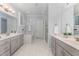 Bright main bathroom with double vanity, soaking tub, and glass-enclosed shower at 2832 Thompson Bluff Dr, Cary, NC 27519