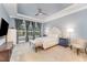 Large main bedroom with tray ceiling, ceiling fan, sitting area, and bright windows at 2832 Thompson Bluff Dr, Cary, NC 27519