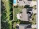 Overhead view of a property with a green lawn, patio, deck, swimming pool, and neighboring houses at 2905 Pluton Pl, Rolesville, NC 27571