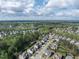 An aerial view of a vast residential community surrounded by green spaces and nature, showing density at 2905 Pluton Pl, Rolesville, NC 27571