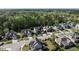 Community aerial showcasing lush greenery, well-spaced homes, and neighborhood streets in a peaceful suburban setting at 2905 Pluton Pl, Rolesville, NC 27571