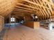 Unfinished attic space with wood framing and flooring, offering potential for future expansion at 2905 Pluton Pl, Rolesville, NC 27571