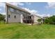 Expansive backyard with a wooden deck, stone fire pit, and ample space for outdoor activities at 2905 Pluton Pl, Rolesville, NC 27571