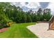 A well-maintained backyard features a manicured lawn and a spacious stone patio at 2905 Pluton Pl, Rolesville, NC 27571