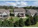 A well-maintained backyard featuring a deck, patio, and lush green lawn surrounded by trees at 2905 Pluton Pl, Rolesville, NC 27571