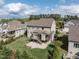 Aerial view of backyard with patio, deck, and green lawn, nestled in a residential neighborhood with mature trees at 2905 Pluton Pl, Rolesville, NC 27571