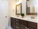 Elegant bathroom with double vanity, dark wood cabinets, and framed mirrors at 2905 Pluton Pl, Rolesville, NC 27571