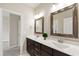 This double vanity bathroom features marble counters and dark wood cabinets at 2905 Pluton Pl, Rolesville, NC 27571