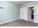 Light blue bedroom with ensuite bathroom and walk-in closet with double doors at 2905 Pluton Pl, Rolesville, NC 27571