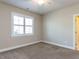 Light neutral bedroom with a ceiling fan and a view of the front yard at 2905 Pluton Pl, Rolesville, NC 27571