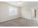 This bedroom is carpeted and features a ceiling fan and a sunny window at 2905 Pluton Pl, Rolesville, NC 27571