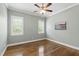 Empty bedroom with light green walls and hardwood floors at 2905 Pluton Pl, Rolesville, NC 27571