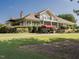 The community clubhouse features a spacious porch, stone details, and mature landscaping at 2905 Pluton Pl, Rolesville, NC 27571