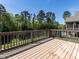 Spacious wooden deck surrounded by lush greenery and trees, perfect for outdoor entertaining at 2905 Pluton Pl, Rolesville, NC 27571