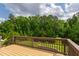 A wooden deck overlooks a verdant backyard framed by mature trees and lush greenery at 2905 Pluton Pl, Rolesville, NC 27571