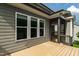 Back deck view of grey siding and screened porch at 2905 Pluton Pl, Rolesville, NC 27571