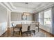 Sophisticated dining room with a large table, stylish seating, and a decorative lighting fixture at 2905 Pluton Pl, Rolesville, NC 27571