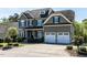 Lovely two-story home boasts an attached two-car garage, driveway, and lush landscaping at 2905 Pluton Pl, Rolesville, NC 27571