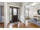 Elegant foyer featuring hardwood floors, a stylish front door, and an adjacent home office at 2905 Pluton Pl, Rolesville, NC 27571