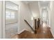 A beautiful staircase and hallways feature hardwood floors with lots of natural light at 2905 Pluton Pl, Rolesville, NC 27571