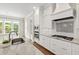 Modern kitchen boasts white cabinets, granite countertops, stainless steel appliances, and breakfast nook at 2905 Pluton Pl, Rolesville, NC 27571