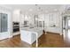 Elegant kitchen features white cabinets, stainless appliances, hardwood floors, and a large island at 2905 Pluton Pl, Rolesville, NC 27571