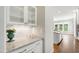 Stylish kitchen with white cabinets, granite countertops, and an open view into the dining area at 2905 Pluton Pl, Rolesville, NC 27571