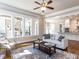 Bright living room with natural light, hardwood floors, and open view to the backyard patio and kitchen at 2905 Pluton Pl, Rolesville, NC 27571
