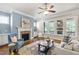 Cozy living room with a fireplace, large windows, and comfortable seating arrangement at 2905 Pluton Pl, Rolesville, NC 27571