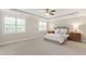 Spacious main bedroom boasts neutral tones, a ceiling fan, and bright natural light at 2905 Pluton Pl, Rolesville, NC 27571