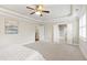 Open and airy main bedroom with a ceiling fan, neutral tones and multiple entryways at 2905 Pluton Pl, Rolesville, NC 27571