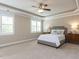 Bright bedroom with a decorative tray ceiling, bedside tables, and neutral colors at 2905 Pluton Pl, Rolesville, NC 27571