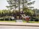 Community playground featuring slides and climbing structure, surrounded by a secure black metal fence at 2905 Pluton Pl, Rolesville, NC 27571