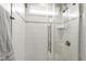 Modern shower with glass door, white subway tile, and rain shower head at 2905 Pluton Pl, Rolesville, NC 27571