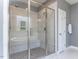 Shower with glass door, grey tiling, shower head and built in bench at 2905 Pluton Pl, Rolesville, NC 27571
