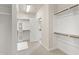 Walk-in closet features built in shelves, coat racks, and bench seating at 2905 Pluton Pl, Rolesville, NC 27571