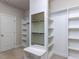 Bright walk-in closet featuring custom shelving and a full-length mirror for added convenience at 2905 Pluton Pl, Rolesville, NC 27571