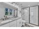 Modern bathroom features a double sink vanity, granite countertop, and marble tile shower with glass enclosure at 3 Maple St, Raleigh, NC 27610