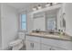 Well-lit bathroom featuring a double vanity with undermount sinks, granite countertops and modern fixtures at 3 Maple St, Raleigh, NC 27610
