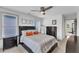 Cozy bedroom with a ceiling fan, three windows, and tasteful decor, creating a restful and inviting space at 3 Maple St, Raleigh, NC 27610